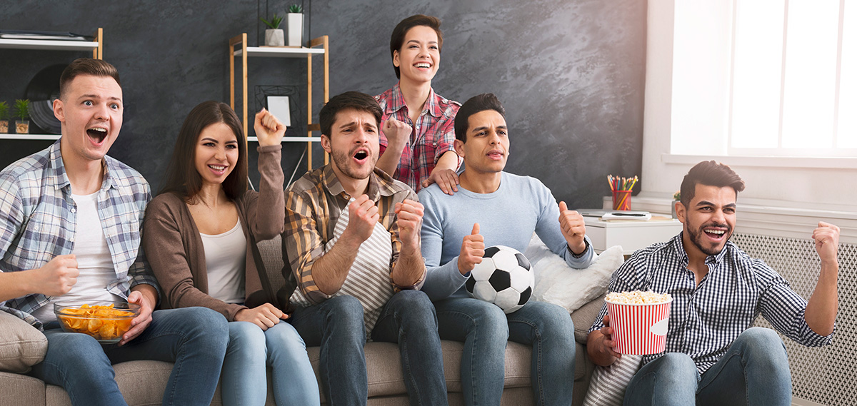 Latino friends watching streaming futbol together