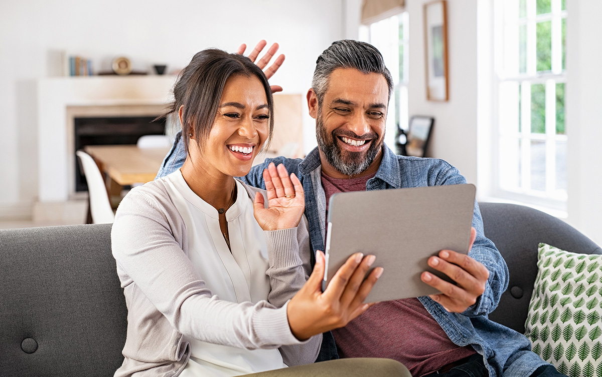 Latino couple using fiber internet for video chat with family